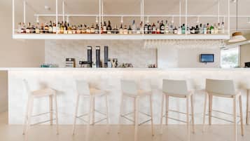 A modern bar area with multiple liquor bottles, a wine cooler, and a bar counter.