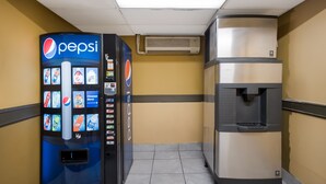 A vending machine and a water dispenser in a hallway. - Econo Lodge Allentown North (Allentown)