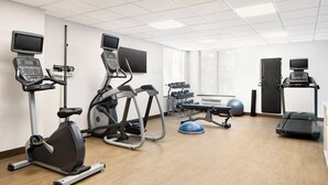 A fitness center with treadmills, elliptical machines, and a rowing machine.