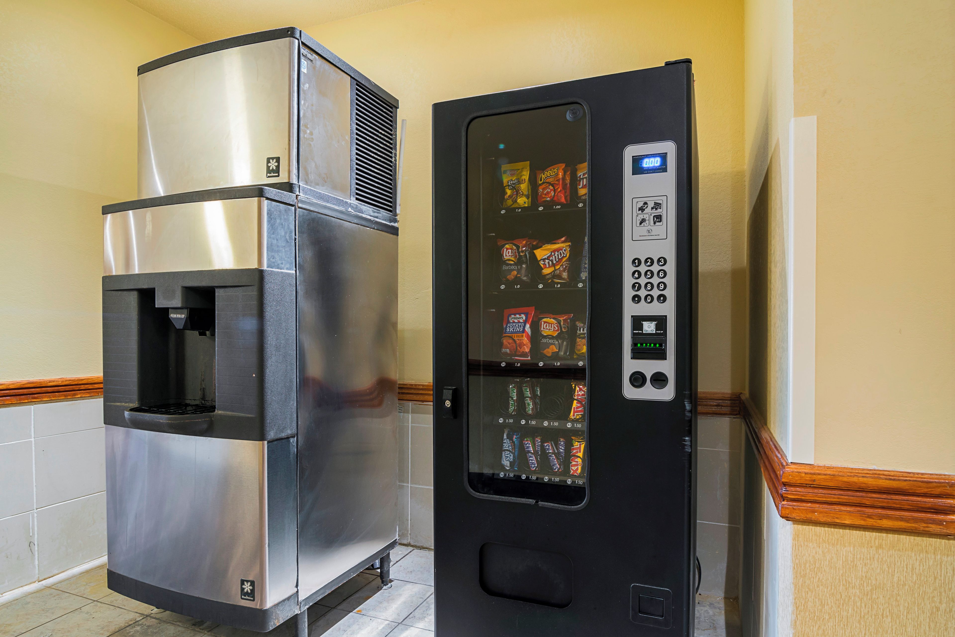 A vending machine with a selection of snacks and a water dispenser.