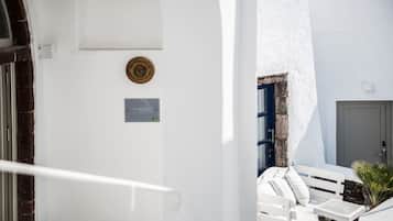 A white building with a blue door and a sign that reads "The ROCKS."