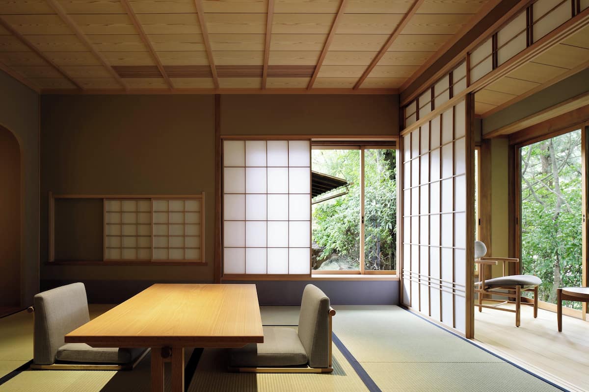 A traditional Japanese room with tatami flooring, a low wooden table, and sliding shoji doors.