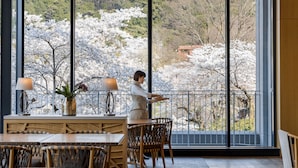 Un comedor con vistas a los cerezos en flor a través de amplios ventanales.