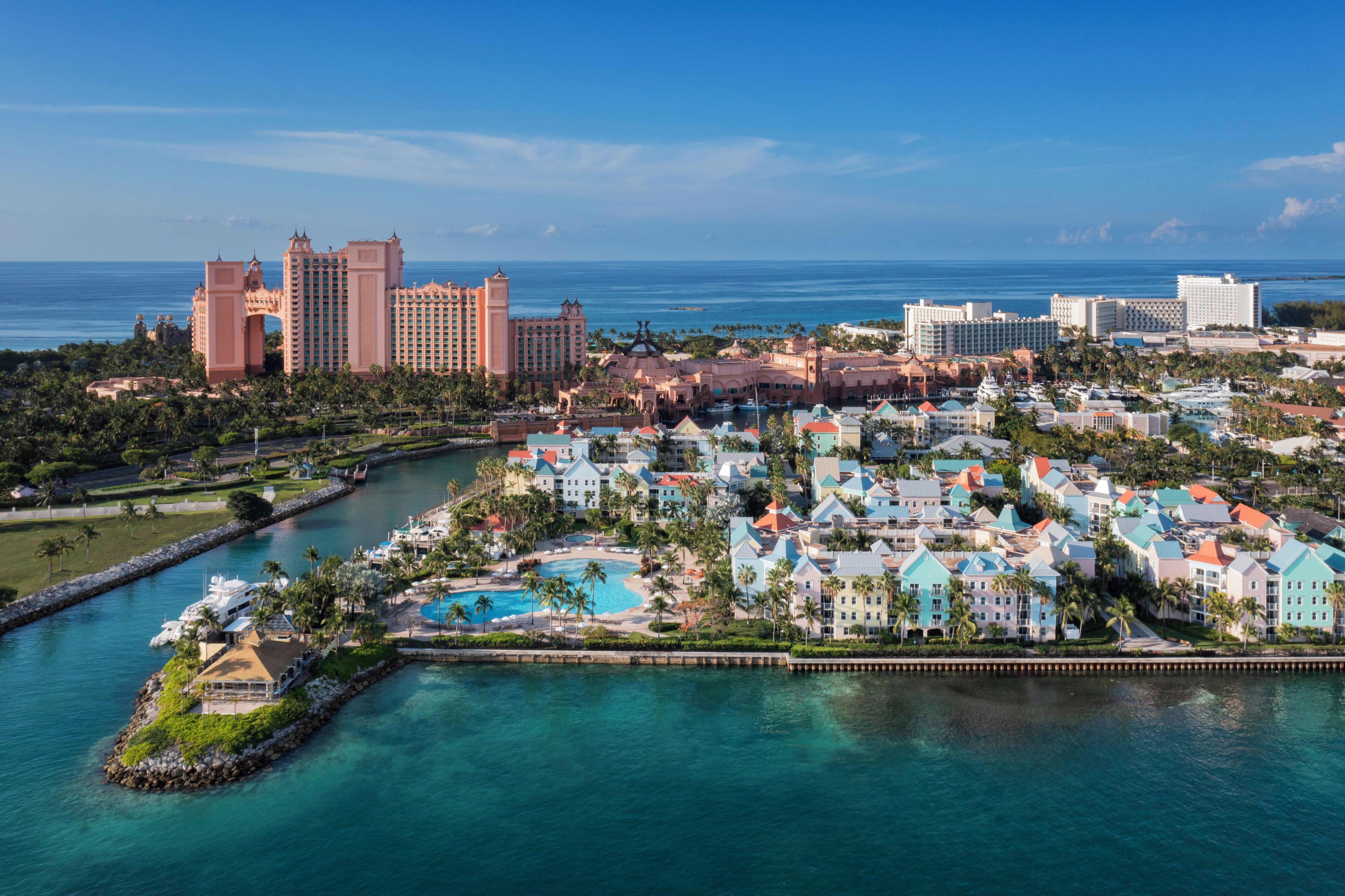 A resort with multiple buildings, a large pool, and a marina.