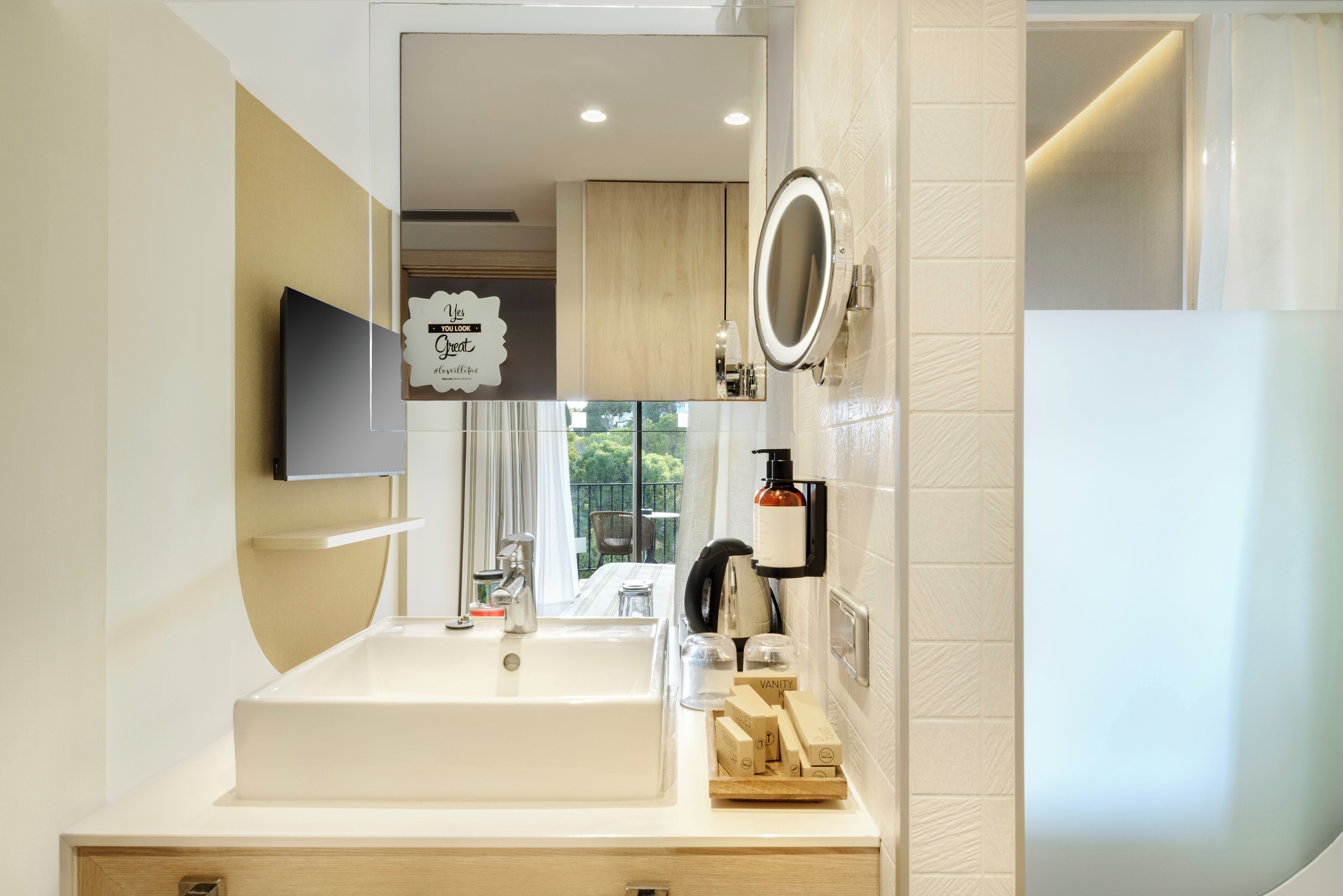 A modern bathroom with a large sink, mirror, and vanity.