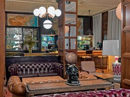 A bar area with leather seating, a globe, and a map on the wall.