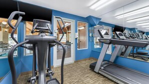 A gym with treadmills, an elliptical, and a mirrored wall. - Comfort Inn Fontana (Fontana)