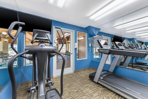 A gym with treadmills, an elliptical, and a mirrored wall. - Comfort Inn Fontana (Fontana)