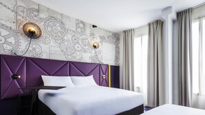 A hotel room with a bed, a nightstand, a wall with a mechanical design, and a window with curtains. - Ibis Styles Paris Mairie de Clichy (Clichy)