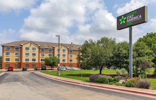 A multi-story hotel with a sign for Extended Stay America Suites.