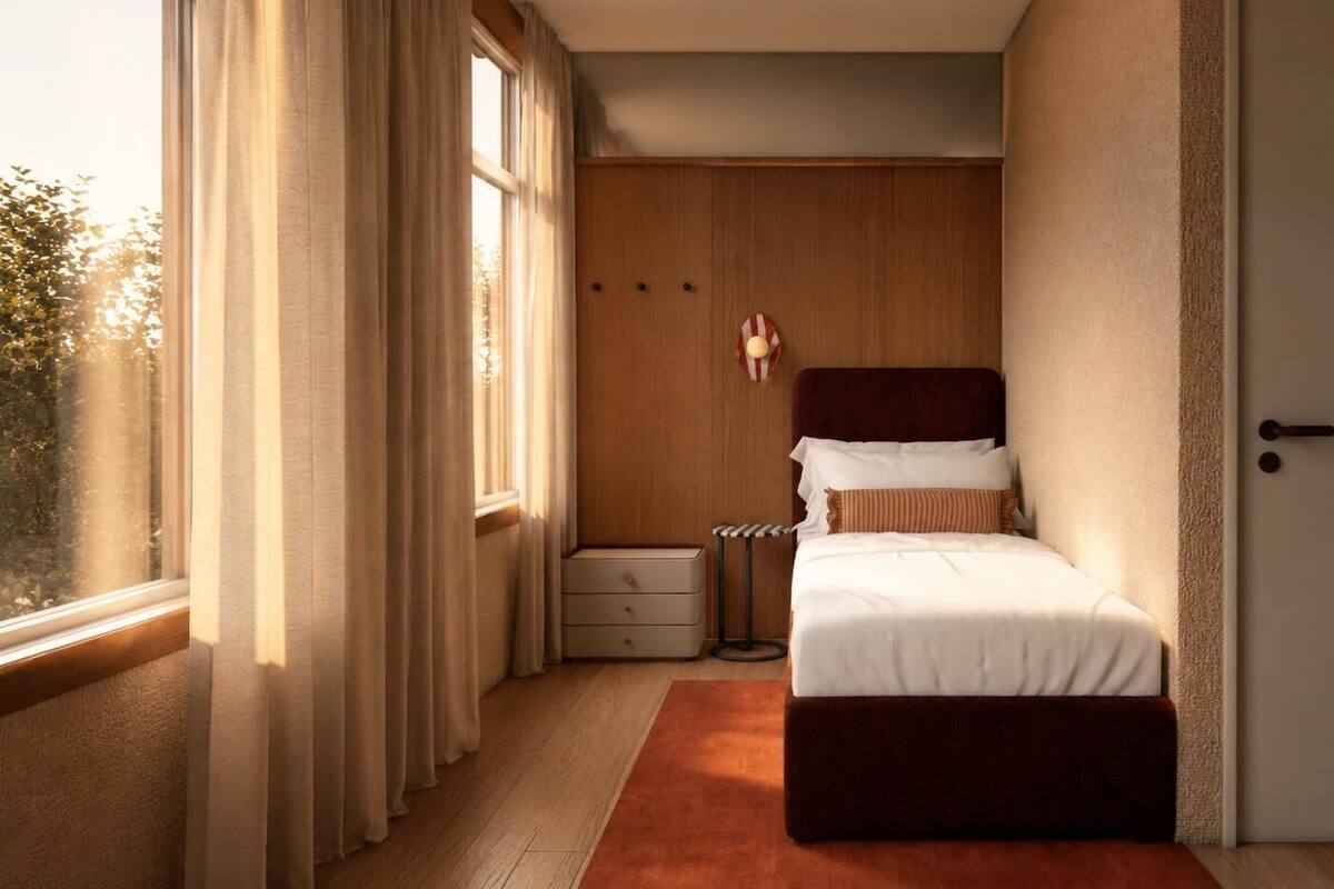A bedroom with a bed, a nightstand, a dresser, and a door.