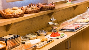 A buffet setup with various food items and utensils. - Ambient Hotel Am Europakanal (Fuerth)