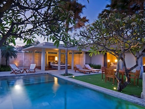 A modern poolside area with lounge chairs and a covered seating area. - The Balé Nusa Dua by LifestyleRetreats (Nusa Dua)