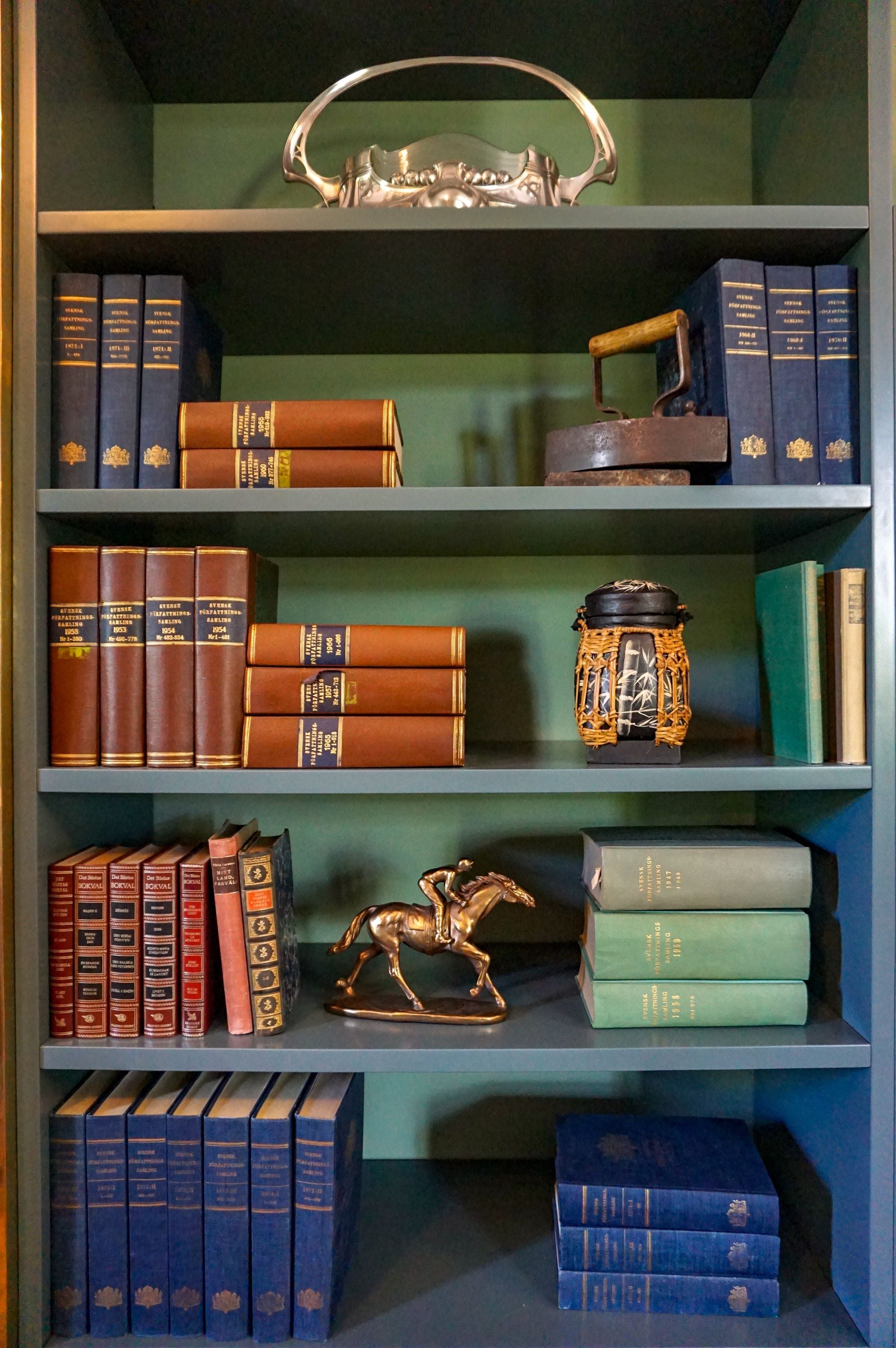 A bookshelf with various books and decorative items.