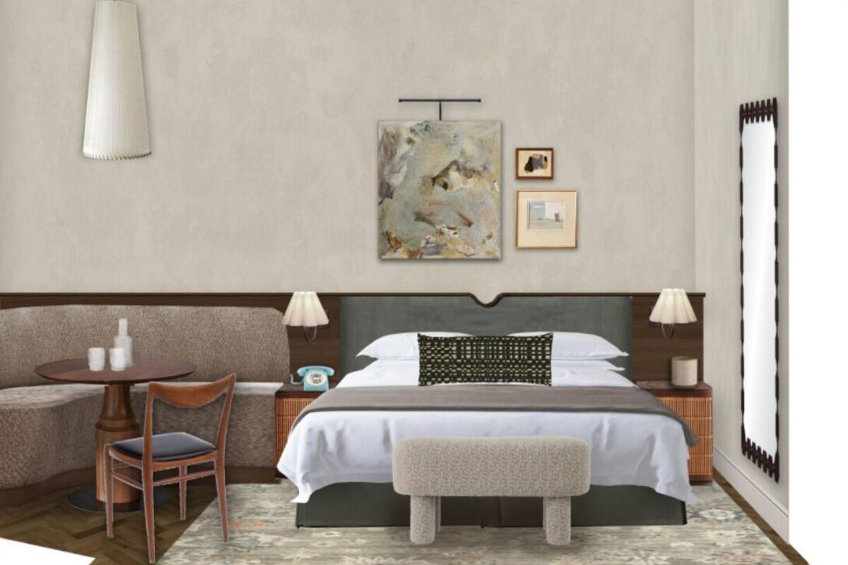 A bedroom with a bed, bedside tables, a chair, a small table, and artwork on the wall.