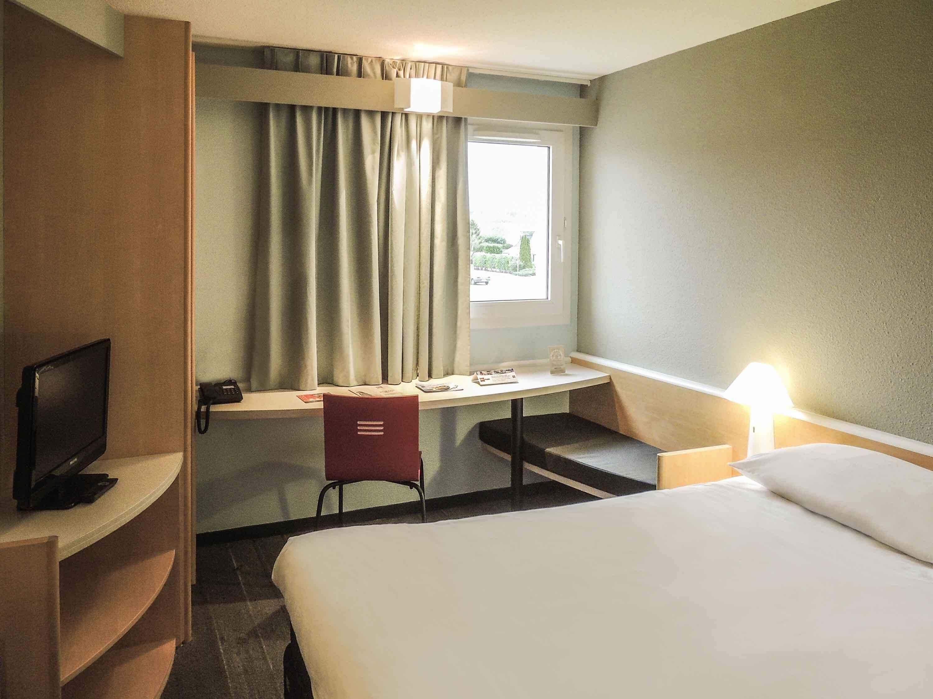 Premium bedding, desk, laptop workspace, blackout curtains