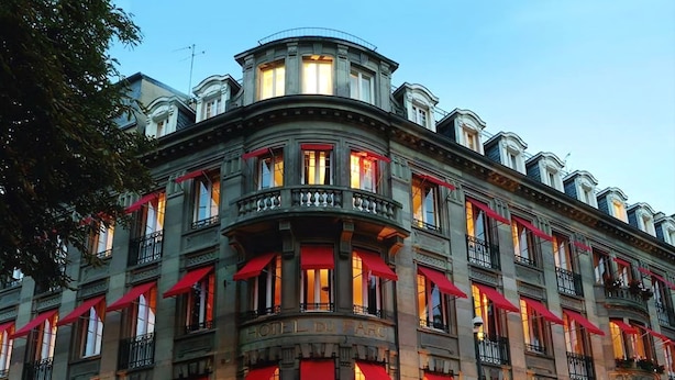 A historic building with multiple balconies, red awnings, and a ground-floor entrance labeled "Hotel Du Parc." - Hotel du Parc - Centre Ville (Mulhouse)