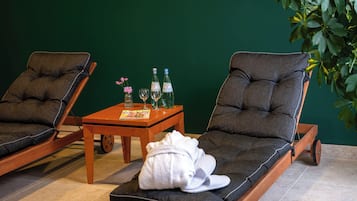 Relax in a serene spa area with two reclining chairs and a tranquil atmosphere.