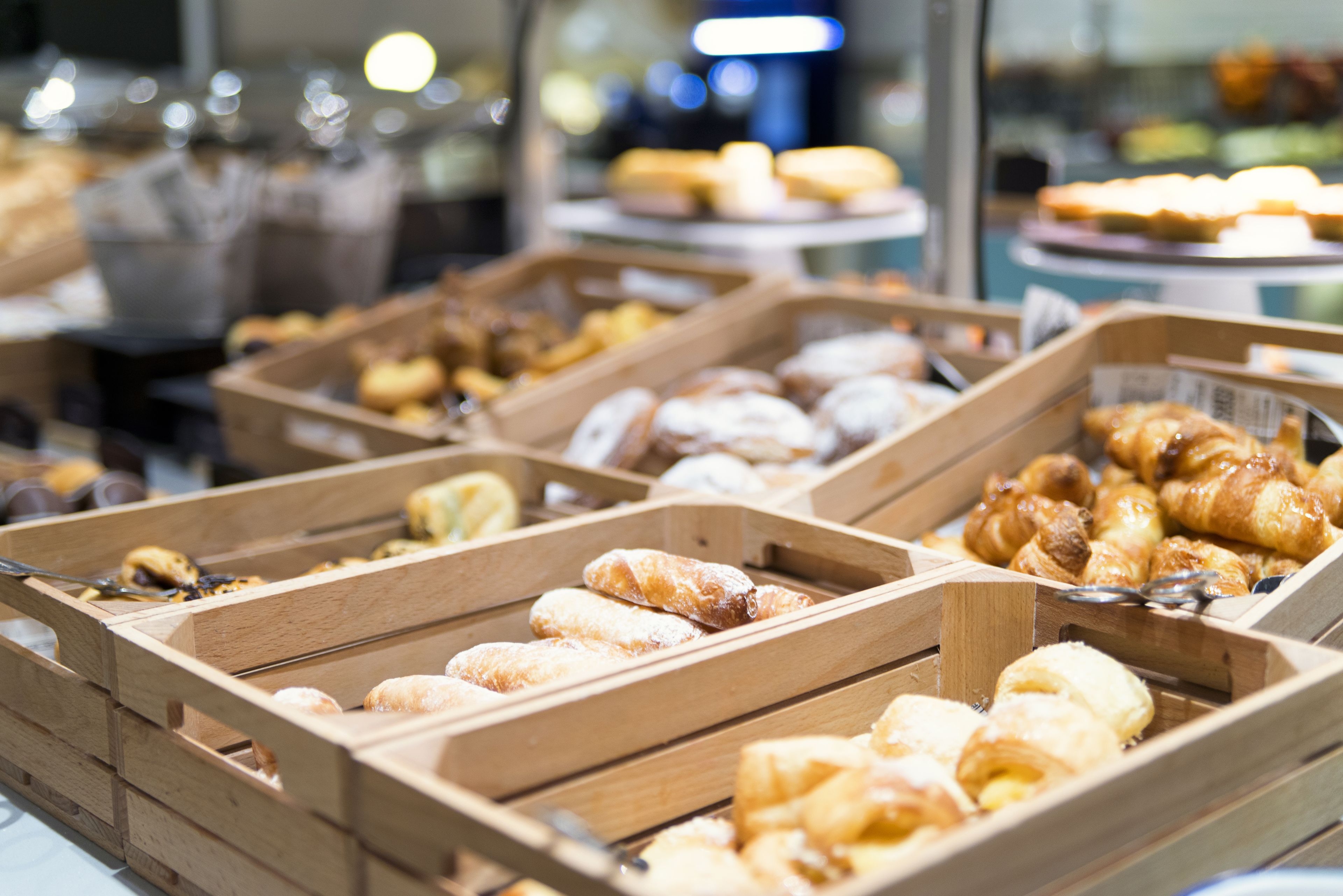 Wooden trays filled with various pastries and baked goods.