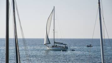A sailboat on calm waters with a clear sky.