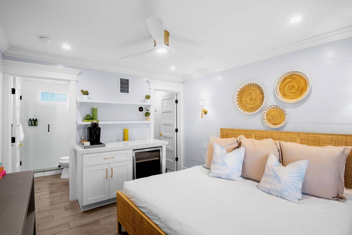A modern bedroom with a bed, bedside tables, and a built-in wardrobe.