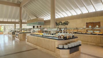 A spacious indoor area with high ceilings and a central buffet counter.