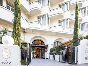 A hotel entrance with a classic facade, arched windows, and a central entrance. - The 1932 Hotel & Spa Cap d'Antibes - MGallery Collection (Antibes)