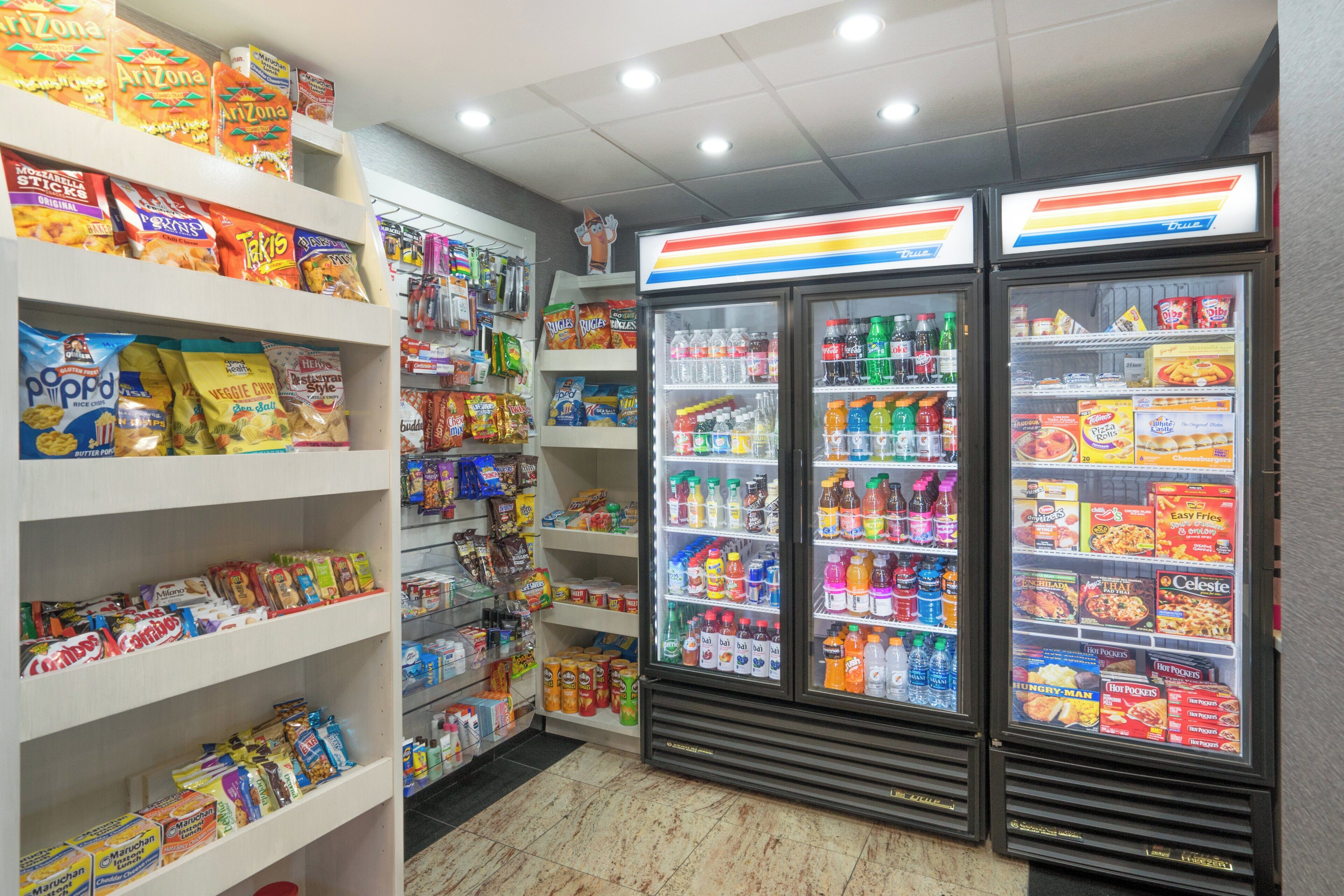 A snack and beverage vending area with various snack options and a selection of sodas.