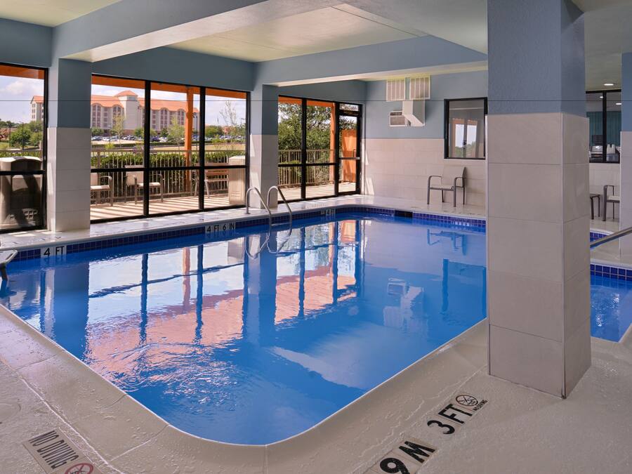 An indoor swimming pool with clear blue water, a 4 FT 6 IN depth, and a 9 M width.