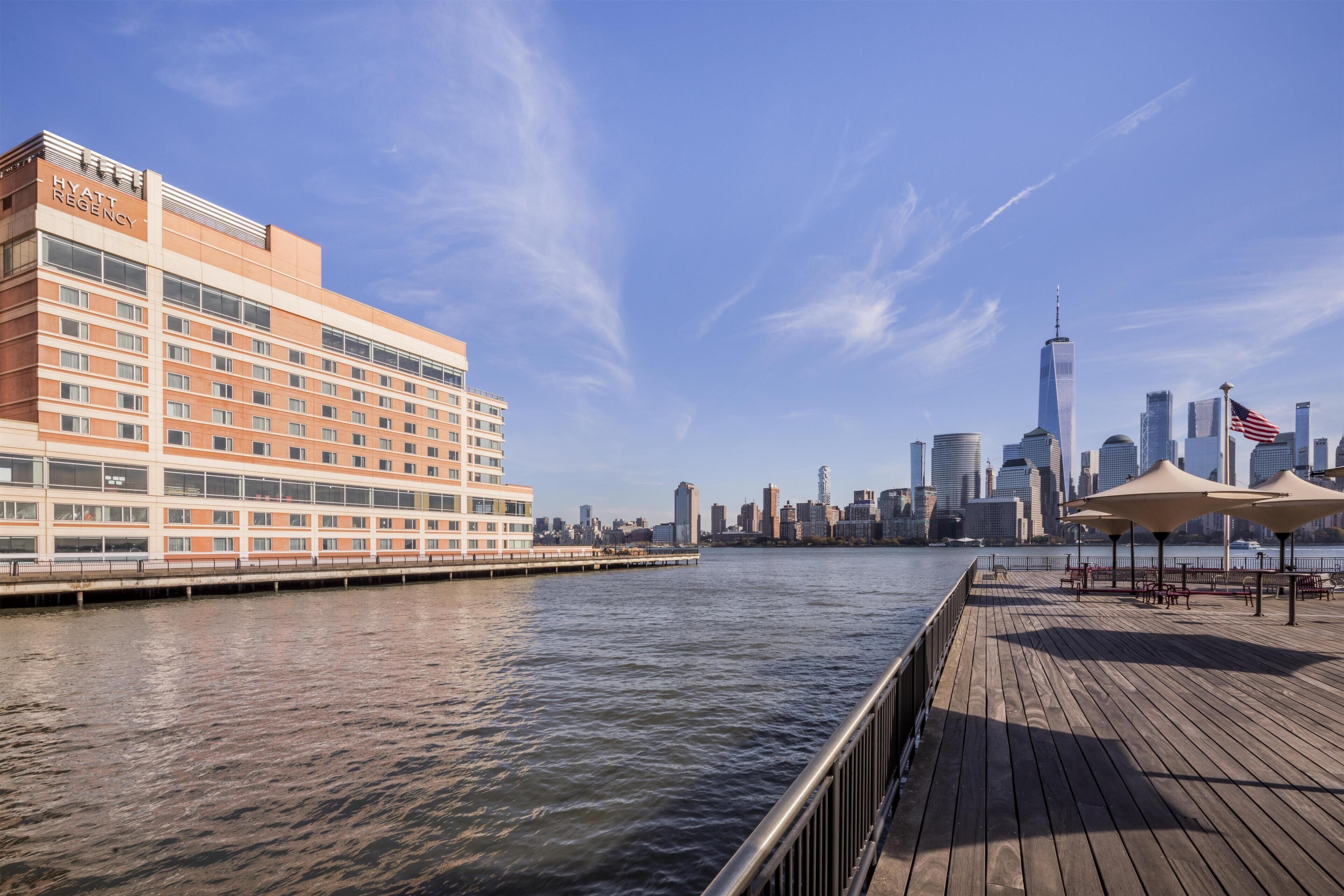 A waterfront hotel with a view of the city skyline.