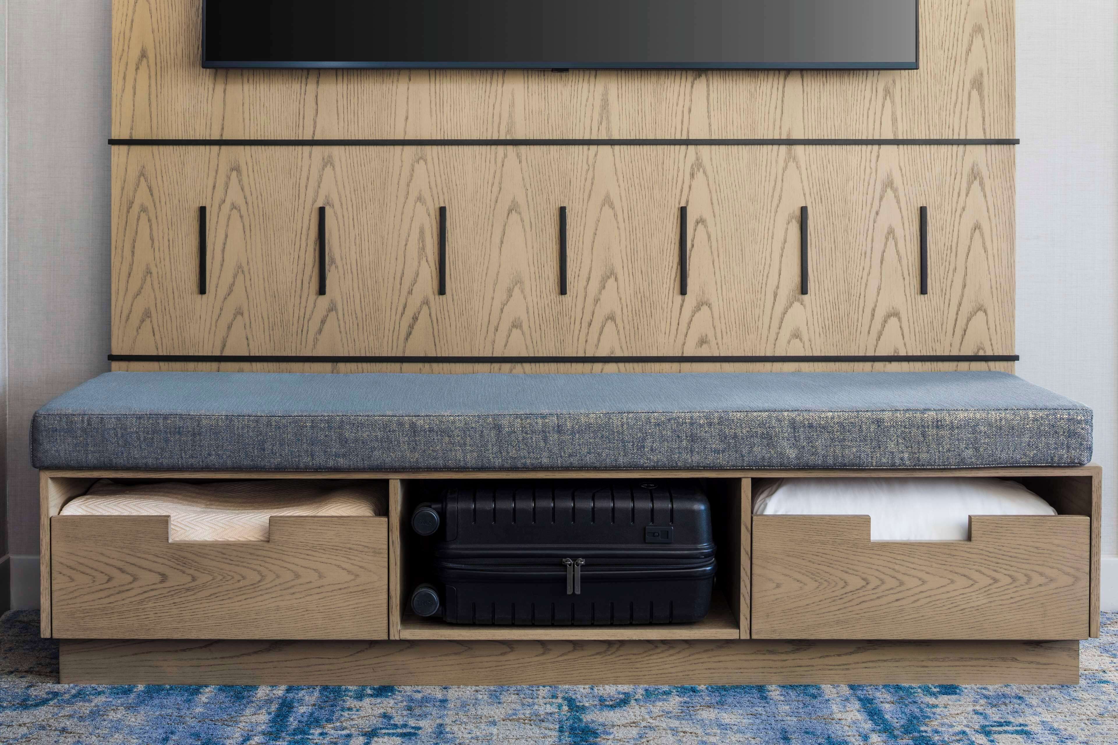 A wooden cabinet with a flat-screen TV mounted above it.