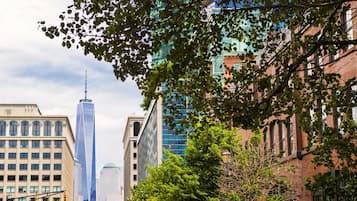 A cityscape with modern buildings, including a prominent skyscraper.