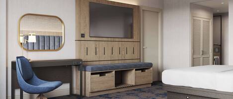 A hotel room with a bed, a desk with a chair, a TV, and a wardrobe.
