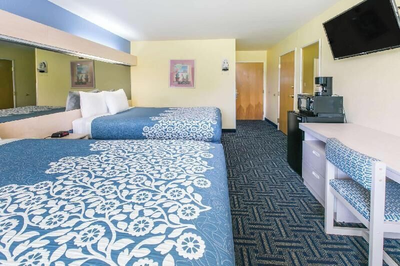 Premium bedding, desk, laptop workspace, blackout drapes