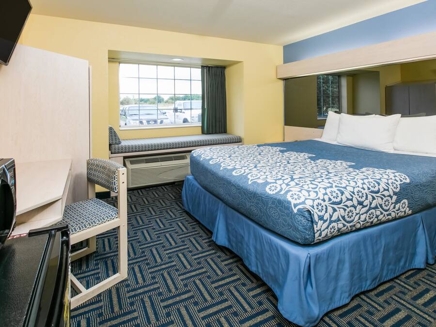 Premium bedding, desk, laptop workspace, blackout curtains