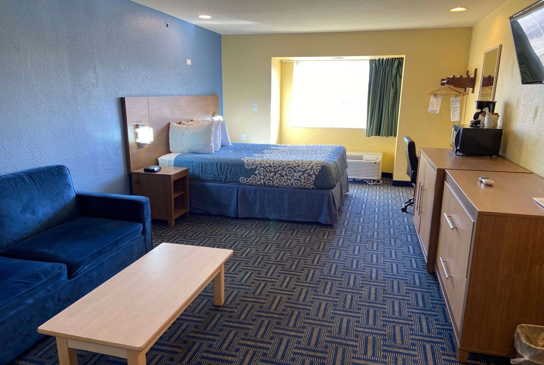 Premium bedding, desk, laptop workspace, blackout drapes