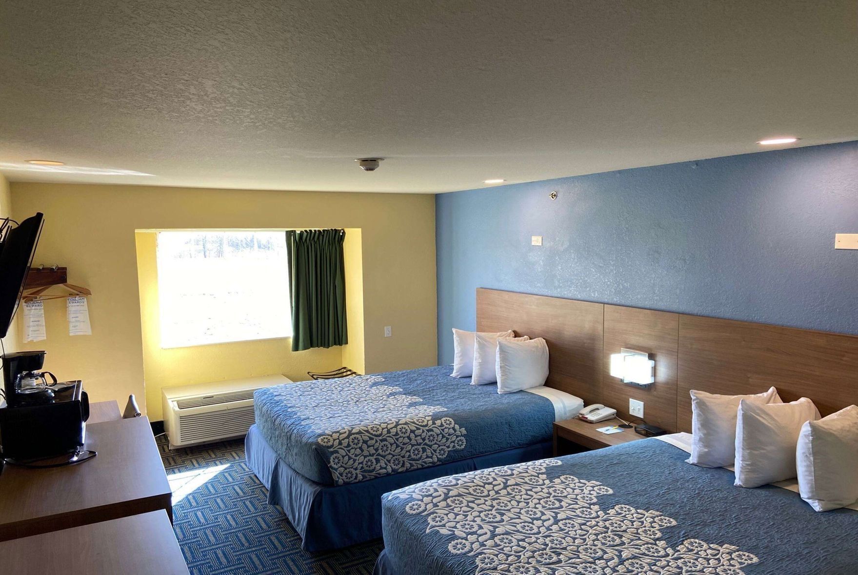 Premium bedding, desk, laptop workspace, blackout drapes