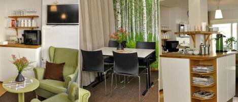 A modern living room with a green sofa, a small round table, and a TV on the wall.