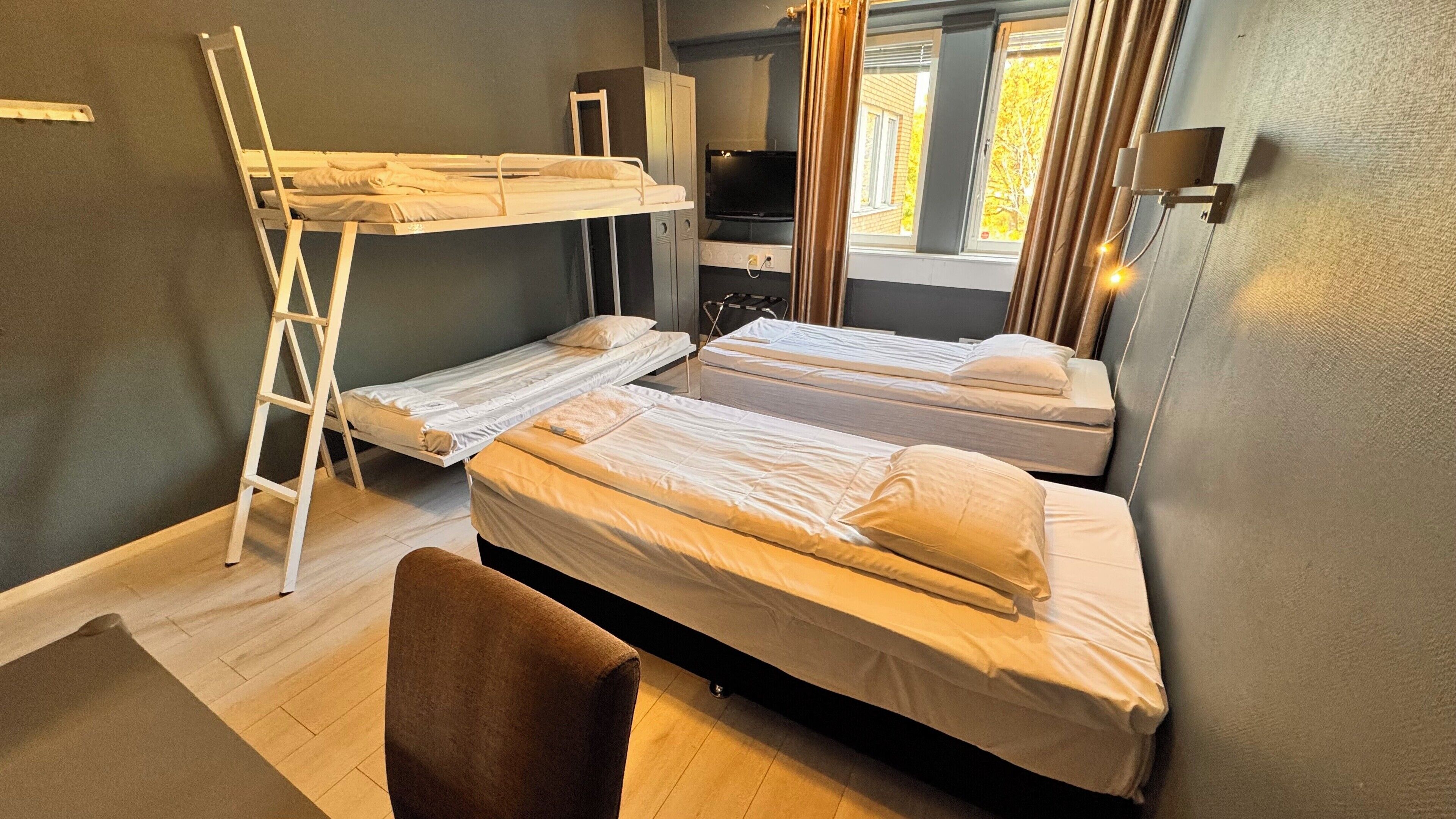 Economy Quadruple Room, Shared Bathroom | Individually decorated, individually furnished, desk, iron/ironing board