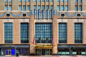 A building with a facade featuring a large central entrance, flanked by windows and decorative elements. - Residence Inn by Marriott Philadelphia Center City (Philadelphia)