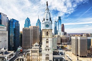 Standing tall in the heart of the city, this historic clock tower features a classical design with a tall spire and clock face.