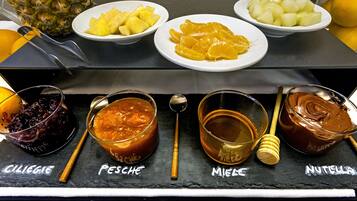 A selection of fruits and condiments on a table.