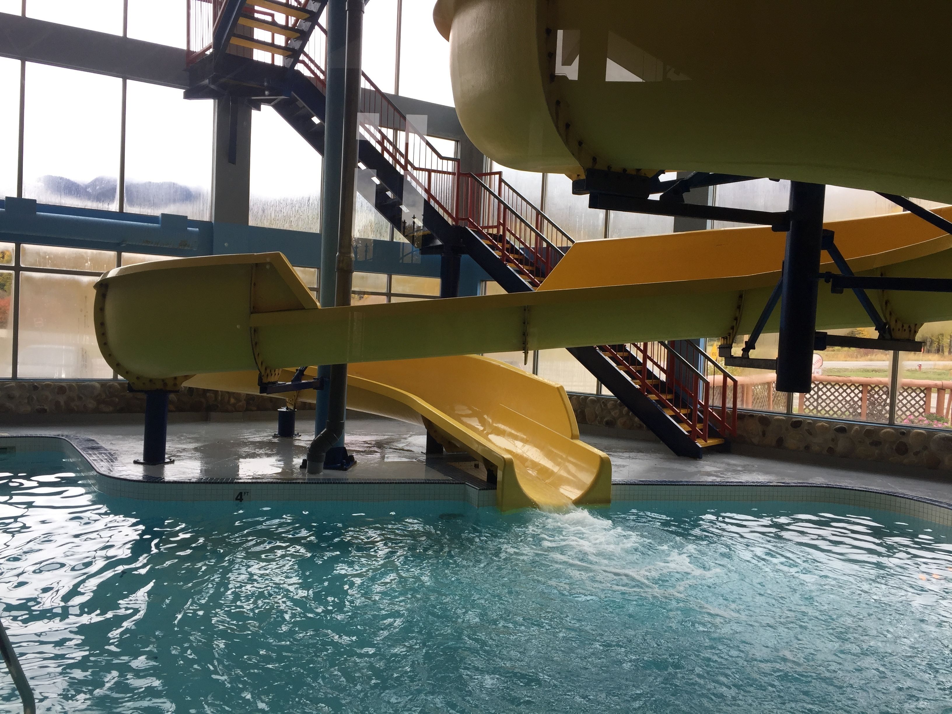 An indoor water park with multiple slides and a pool.
