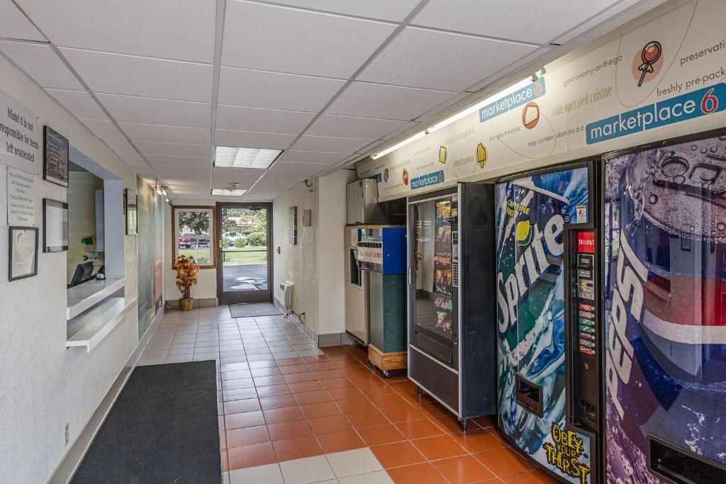 A hallway with a reception desk, a vending machine, and a sign for 'marketplace 6'.
