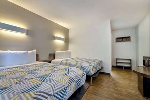 A hotel room with two beds, a bedside table, a desk, and a wall-mounted shelf. - Motel 6 Oshkosh, WI (Oshkosh)