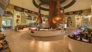 A spacious lobby with a central bar area, high ceilings, and decorative lighting fixtures. - Iberostar Selection Hacienda Dominicus - All Inclusive (San Rafael del Yuma)