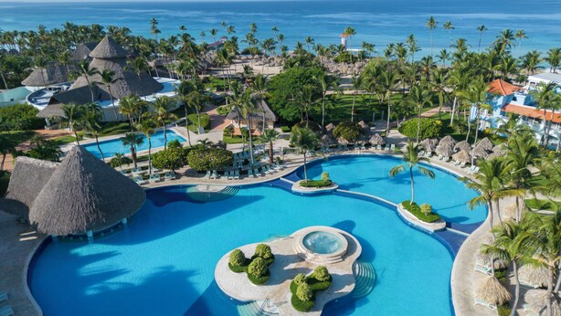 A resort with a large central pool, smaller pools, and thatched-roof structures. - Iberostar Selection Hacienda Dominicus - All Inclusive (San Rafael del Yuma)