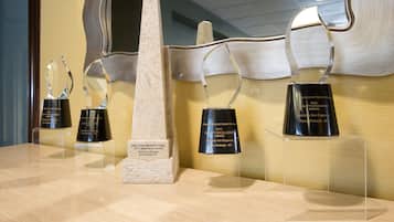 Awards displayed on a wall, including a 2013 renovation award and a 2009 quality excellence award.
