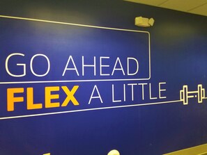 A wall with motivational text "GO AHEAD FLEX A LITTLE".