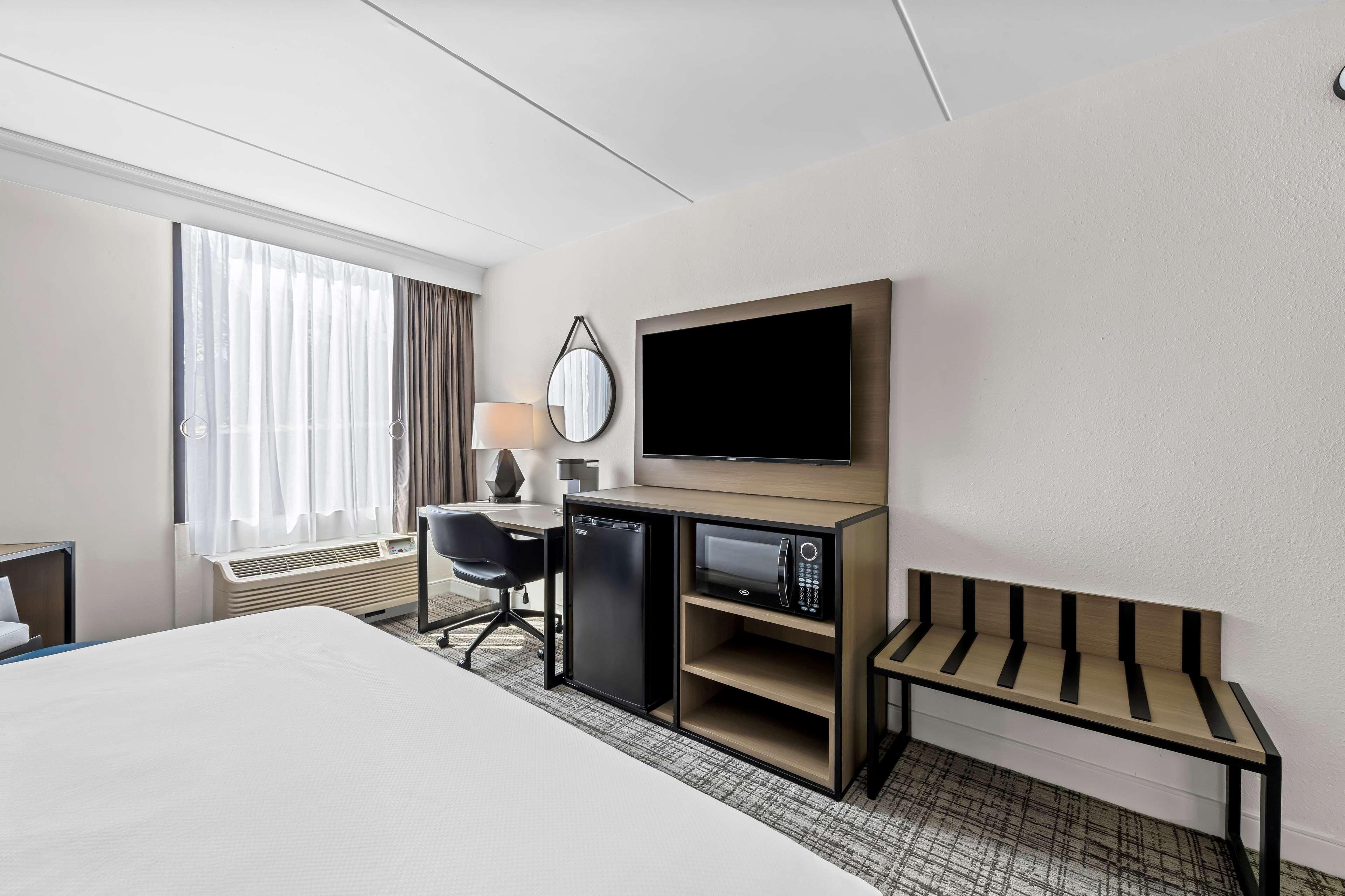 Desk, laptop workspace, blackout drapes, iron/ironing board